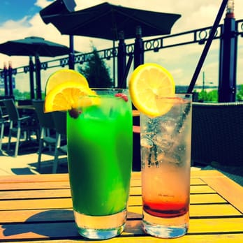 La Cage - two cocktails on a wooden table - Sports Bars Near Me - Montreal, Quebec La Cage - two cocktails on a wooden table - Sports Bars Near Me - Montreal, Quebec