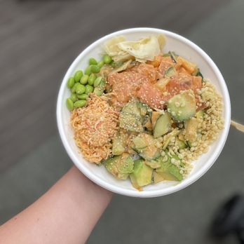 Just Poké Factoria - a person holding a bowl of food - Poke Near Me - Bellevue, Washington
