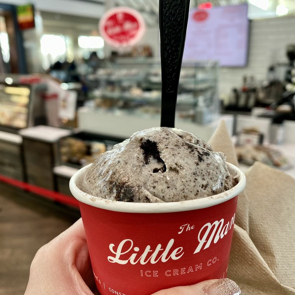 a hand holding a cup of ice cream a hand holding a cup of ice cream