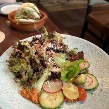 Tiffins Restaurant - THE LAND SALAD - $14 - Young Lettuces from the Land Pavilion at EPCOT, Muhammara, Feta, Sumac, Garlic Breadcrumbs, Citrus Vinaigrette. - New American Near Me - Lake Buena Vista, Florida Tiffins Restaurant - THE LAND SALAD - $14 - Young Lettuces from the Land Pavilion at EPCOT, Muhammara, Feta, Sumac, Garlic Breadcrumbs, Citrus Vinaigrette. - New American Near Me - Lake Buena Vista, Florida