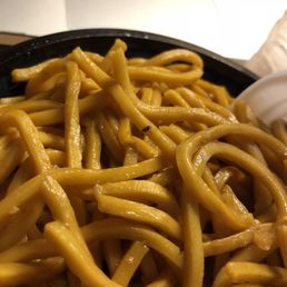 a bowl of noodles and a laptop a bowl of noodles and a laptop