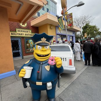 Simpsons Land - Captain Wiggum! Buy a Lard Lad donut and take a selfie with you and your donut next to the Cap. - Amusement Parks Near Me - Los Angeles, California Simpsons Land - Captain Wiggum! Buy a Lard Lad donut and take a selfie with you and your donut next to the Cap. - Amusement Parks Near Me - Los Angeles, California