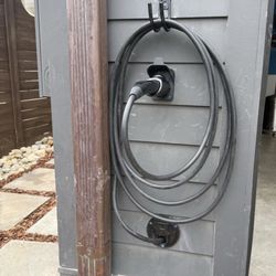 Mikes Electric - EV charger holster outside of garage.