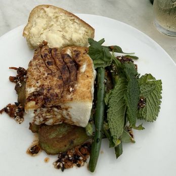 Woods Hill Pier 4 - The most amazing halibut. It is locally sourced and prepared with leek & scallion pancake, charred green beans, chili crisp, summer herbs . - New American Near Me - Boston, Massachusetts Woods Hill Pier 4 - The most amazing halibut. It is locally sourced and prepared with leek & scallion pancake, charred green beans, chili crisp, summer herbs . - New American Near Me - Boston, Massachusetts