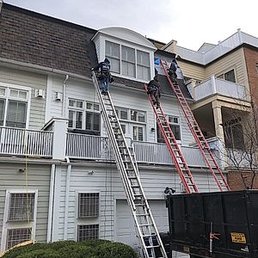 Workers had to use ladders to put the shingles on the vertical portion of the roof. Workers had to use ladders to put the shingles on the vertical portion of the roof.