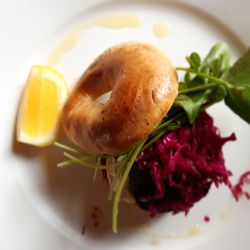 Maranui Cafe - Daily special fresh made bagel w/ black pudding, saurekraut hummuus leafy greens