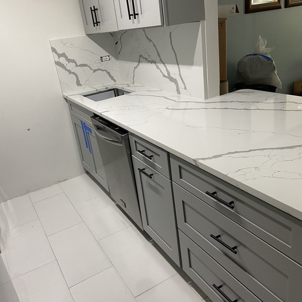 Muriqi Kitchens - a kitchen with a marble counter top - Countertop Installation Near Me - Bronx, New York Muriqi Kitchens - a kitchen with a marble counter top - Countertop Installation Near Me - Bronx, New York