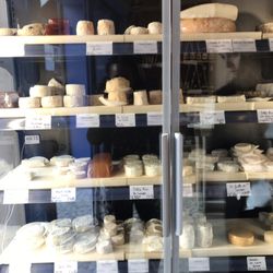 L'Artisan du Lait - Cheese case with just some of their cheeses.