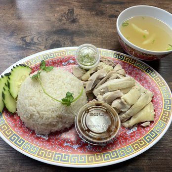 Meng's kitchen - Khao Man Gai, which is Chicken and Rice infused with garlic and ginger with a brown bean sauce and broth. - Singaporean Near Me - Orlando, Florida Meng's kitchen - Khao Man Gai, which is Chicken and Rice infused with garlic and ginger with a brown bean sauce and broth. - Singaporean Near Me - Orlando, Florida