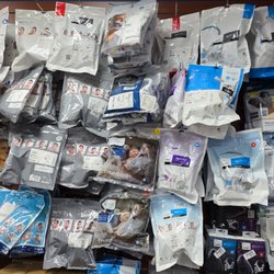 Binson's Medical Equipment and Supplies - Close-up photo of a wall display at the Dearborn store, densely packed with hanging, packaged CPAP masks and accessories.