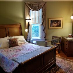 The Yellow House Landrum - Downstairs bedroom. Queen sized bed, sink and fireplace.