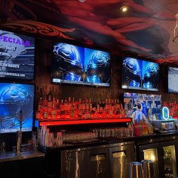 a bar with a lot of tvs a bar with a lot of tvs