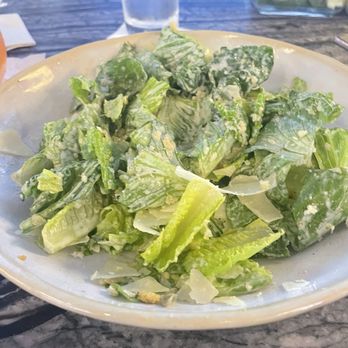 Ten Hands Social Bar & Eatery - Half eaten Caesar salad. It is so good there's Caesar salad dressing is lemon, which is perfect. - New American Near Me - Indianapolis, Indiana