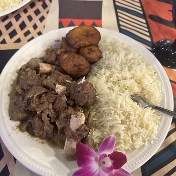 Astor’s Table - Curry goat with white rice and plantains - Steakhouses Near Me - Katy, Texas