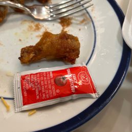 A wing size compared to a standard ketchup packet.