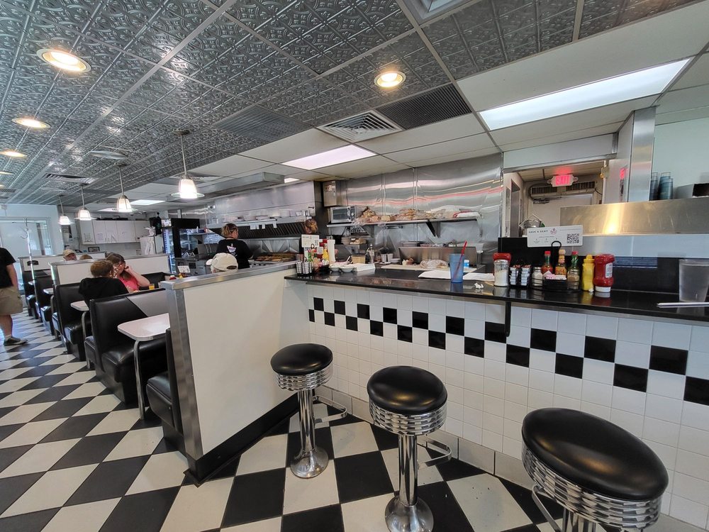 The exterior of the diner, which looks like a silver train car.