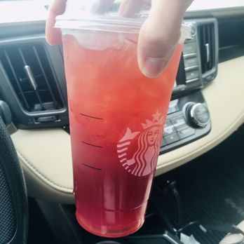 Starbucks - a person holding a drink in a car - Coffee & Tea Near Me - Christiansburg, Virginia Starbucks - a person holding a drink in a car - Coffee & Tea Near Me - Christiansburg, Virginia