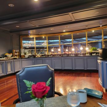 M Bistro - a view of a dining area with a table and chairs - New American Near Me - New Orleans, Louisiana M Bistro - a view of a dining area with a table and chairs - New American Near Me - New Orleans, Louisiana