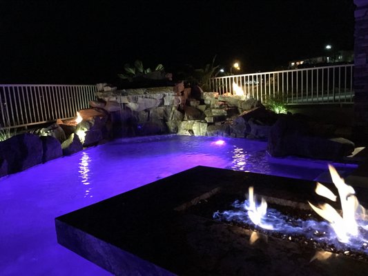 Photo of Lifeguard Pools - Las Vegas, NV, US. Fire pit on patio and fire coming out of both sides of the waterfall. Never gets old looking at it!