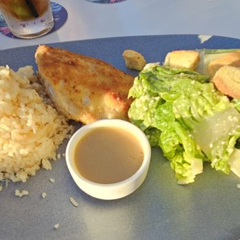 Tommy Bahama - Flavored rice, fresh Macadamia Nut Crusted Mahi Mahi fish, and a Caesar Salad with dressing. - New American Near Me - Kamuela, Hawaii Tommy Bahama - Flavored rice, fresh Macadamia Nut Crusted Mahi Mahi fish, and a Caesar Salad with dressing. - New American Near Me - Kamuela, Hawaii