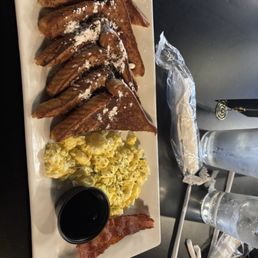 French toast platter with scrambled eggs and a slice bacon. French toast platter with scrambled eggs and a slice bacon.