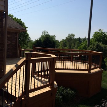 Details Carpentry and Remodeling - a wooden deck with railings - General Contractors Near Me - Rochester Hills, Michigan Details Carpentry and Remodeling - a wooden deck with railings - General Contractors Near Me - Rochester Hills, Michigan