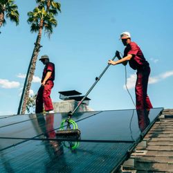 Hardy Boys Window Services - Our technicians tackling  a rooftop solar panel cleaning.