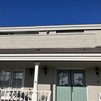 Husky Builders - the front of a house with a green door - General Contractors Near Me Husky Builders - the front of a house with a green door - General Contractors Near Me