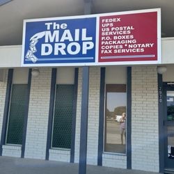 The Mail Drop - Front of business with services listed.