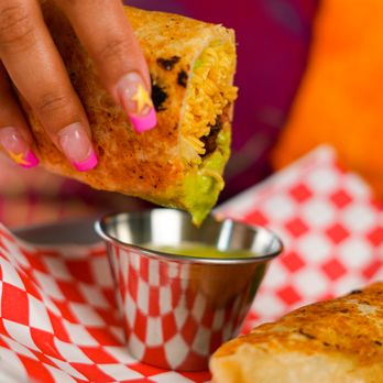 Miso Taco - a person dipping a piece of food - Asian Fusion Near Me - Vancouver, British Columbia