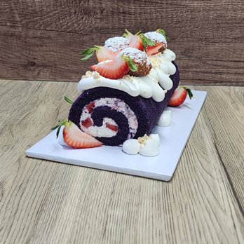 The Baking Endeavor - Ube roll cake with fresh cream and strawberry bits with mango cream puffs and fresh fruits on top - Desserts Near Me The Baking Endeavor - Ube roll cake with fresh cream and strawberry bits with mango cream puffs and fresh fruits on top - Desserts Near Me
