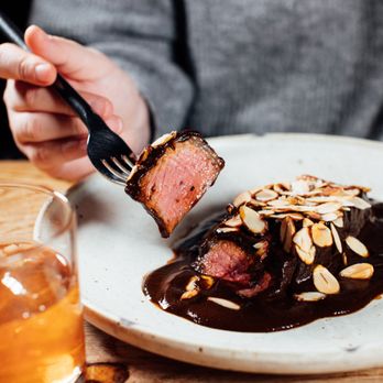 Prospect - a person eating a piece of meat on a plate - Bars Near Me - Hunter, New York Prospect - a person eating a piece of meat on a plate - Bars Near Me - Hunter, New York