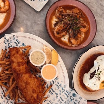 Justine - Fish and Chips on the bottom left with the Shrimp and Grits - French Near Me - New Orleans, Louisiana Justine - Fish and Chips on the bottom left with the Shrimp and Grits - French Near Me - New Orleans, Louisiana