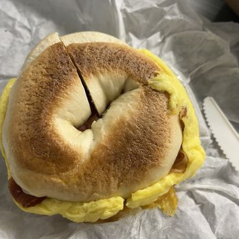 Main Street Bagels - Egg and bacon sandwich on a plain bagel. They got the order wrong and half cut it. - Bagels Near Me - Los Altos, California