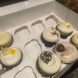 All divine. My fave is the coconut cupcake with passion fruit frosting on the top left