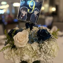 Table centerpiece with custom table number sign.