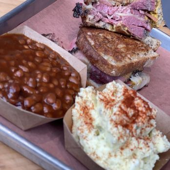 Just Q'in Restaurant - Pastrami sandwich with potato salad and baked beans. - Southern Near Me - Cincinnati, Ohio Just Q'in Restaurant - Pastrami sandwich with potato salad and baked beans. - Southern Near Me - Cincinnati, Ohio