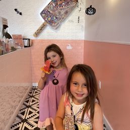 two girls eating pizza