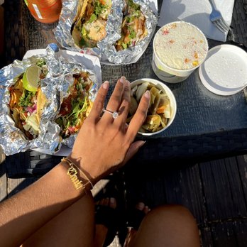 Pablo's Toc O's - a person sitting at a table with food - Food Trucks Near Me Pablo's Toc O's - a person sitting at a table with food - Food Trucks Near Me