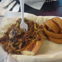 Half size Philly cheese steak with provolone cheese onions rings side. Half size Philly cheese steak with provolone cheese onions rings side.