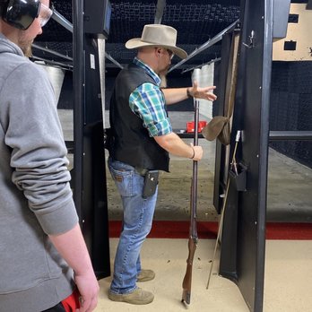 Cody Firearms Experience - Employee explaining the historical significance of the gun while also explaining how it was loaded. - Gun/Rifle Ranges Near Me - Cody, Wyoming
