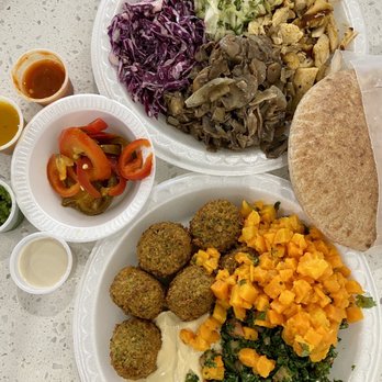 The Green Chicpea - Chicken Platter with red/green cabbage slaw, sautéed mushrooms/onions, and Falafel Platter with carrots salad, spicy tabouli, and hummus - Middle Eastern Near Me - Newark, New Jersey