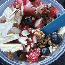 Mango Açaí bowl with blueberries, banana, strawberries, almond slivers, agave drizzle and peanut butter drizzle. Mango Açaí bowl with blueberries, banana, strawberries, almond slivers, agave drizzle and peanut butter drizzle.