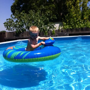 Cannonball Pool & Spa Care - A happy kid in a clear pool - Pool Cleaners Near Me Cannonball Pool & Spa Care - A happy kid in a clear pool - Pool Cleaners Near Me