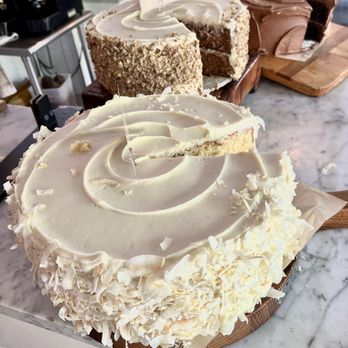 DERU Market - The delicious Coconut cake in the foreground. - Pizza Near Me - Kirkland, Washington DERU Market - The delicious Coconut cake in the foreground. - Pizza Near Me - Kirkland, Washington