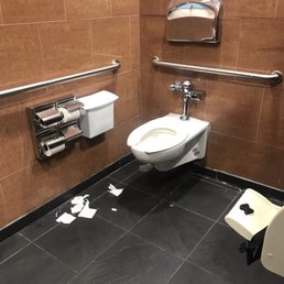 a toilet in a public restroom a toilet in a public restroom