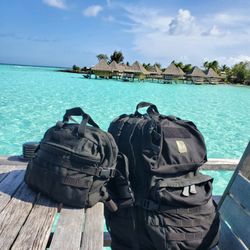 S.O.Tech Tactical - Mission Go Bag (left) and Mission Pack - Expedition (right). All black. I travel with these bags everywhere, even to Bora Bora.
