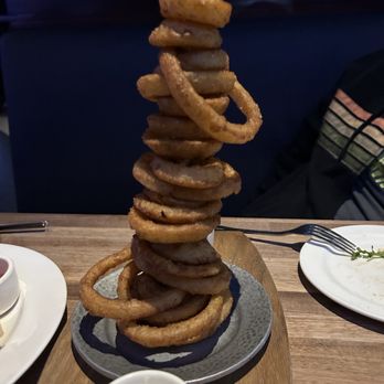 Yard House - Onion Ring Tower- real crispy and perfect. Finished this tower of golden rings. - Bars Near Me - Fresno, California