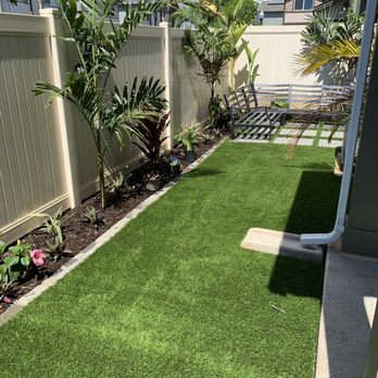 Hapa Landscaping - AFTER: Artificial grass, tropical plants planted, and brick border layer down - Landscaping Near Me - Honolulu, Hawaii Hapa Landscaping - AFTER: Artificial grass, tropical plants planted, and brick border layer down - Landscaping Near Me - Honolulu, Hawaii