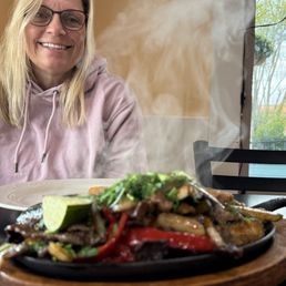 Sizzling, hot fajitas, and a hot chick in the background!